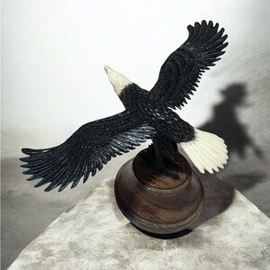 Alaskan bone carved eagle in flight on wood base 4”